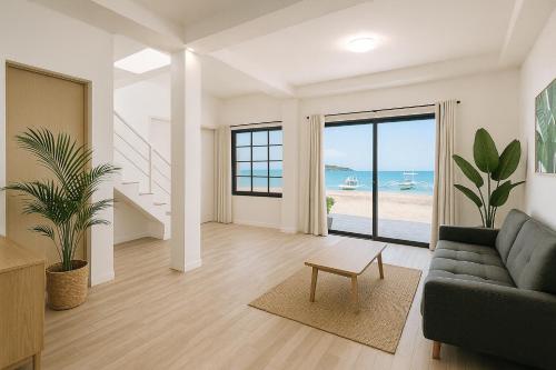 a living room with a couch and a view of the ocean at On-the-beach JADE's BEACH VILLA 별장 Lapu-lapu Olango 별장 in Lapu Lapu City