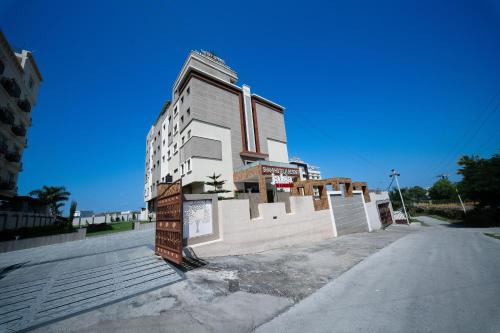 a tall white building sitting on the side of a street at The Sky Imperial - Shahi Hotels & Resort in Nāthdwāra