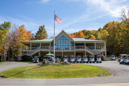 a large house with an american flag in front of it at ML246 Spacious Condo Mtn & Lake views fireplace in Snowshoe