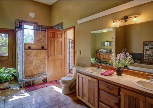 a bathroom with two sinks and a toilet and a shower at Paradise Valley Oasis - Your Yellowstone Base Camp in Flying Y Ranch Airport