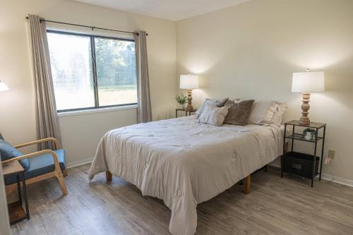 a bedroom with a large bed and a window at 3-Bed Coastal Comfort in Biloxi in Gulfport