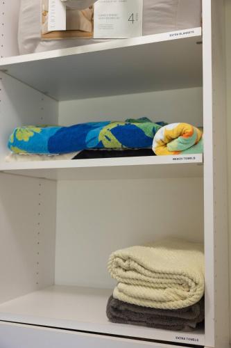 a shelf with a towel and some towels on it at 3-Bed Coastal Comfort in Biloxi in Gulfport