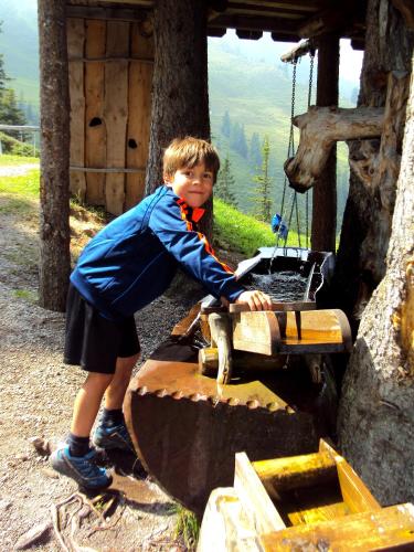 a young boy standing on top of a machine at Landhaus Alpbach in Alpbach