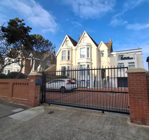 a black fence in front of a house at By-the-Beach, Sea view 2 bedroom Loft Studio Apartment & Free Parking in Portsmouth