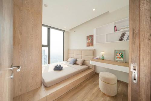 a bedroom with a bed with a stool and a window at Swanlake ecopark Hanoi-Calm homestay in Kim Quan