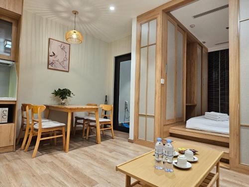 a living room with a table and a bedroom at Swanlake ecopark Hanoi-Calm homestay in Kim Quan