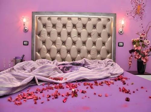 a bedroom with a bed with a bunch of spilled blood at Elysium Luxe Suites in Porto Cesareo