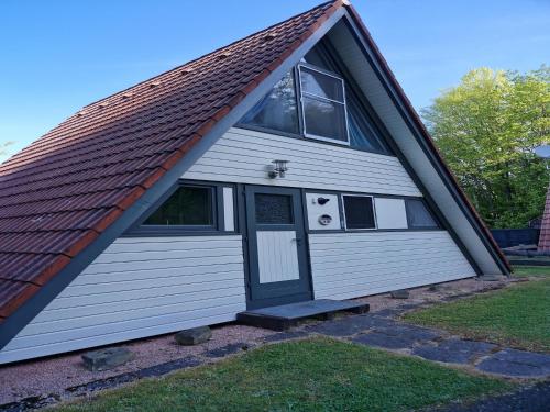 a large white garage with a dog in the window at Holiday Home in Germany with Scenic Views in Ronshausen