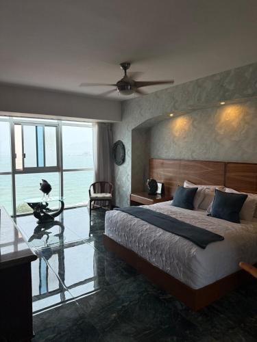 a bedroom with a large bed and a large window at Renta de Depto, Acapulco Gro, Torre Palladio in Acapulco