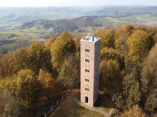 an aerial view of a tower on a hill at Holiday Home in Germany with Idyllic Nature in Berneburg