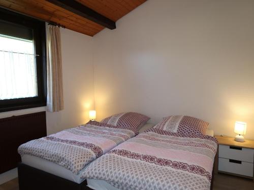 two beds in a bedroom with two lamps on them at Holiday Home in Germany with Idyllic Nature in Berneburg