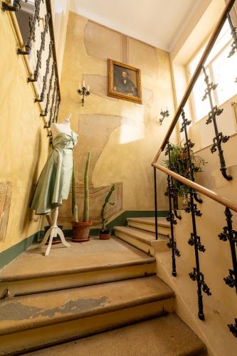 a stairway with a statue of a woman in a dress at Small apartment with 24-hour check-in in Schwechat