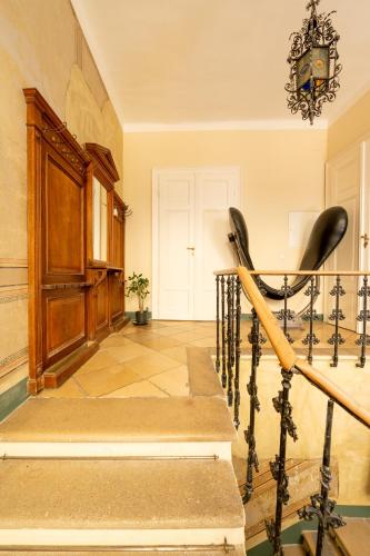 a staircase in a home with a wrought iron railing at Small apartment with 24-hour check-in in Schwechat