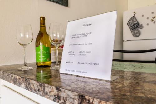 a bottle of wine and two glasses on a counter at Cozy Apt min to Mayo Beaches Free Wi-Fi Coffee Tea in Jacksonville