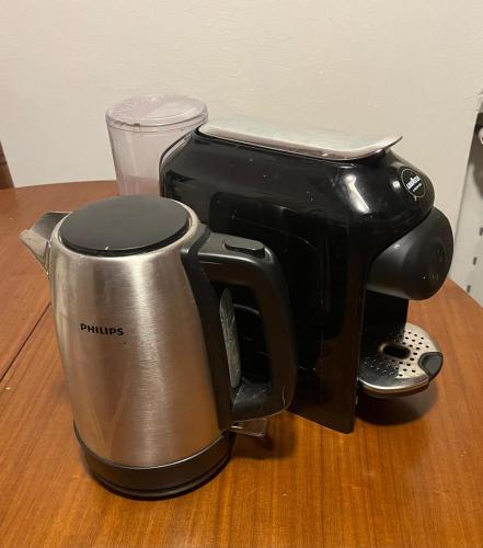 a coffee maker sitting on top of a table at Garden Guest House in Pisa