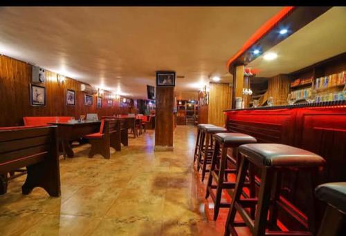 a restaurant with a row of tables and chairs at Madaba nebo home in Amman