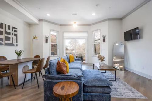 a living room with a blue couch and a table at 2BR - Across from Fairmount Park -10 mins to DT in Philadelphia