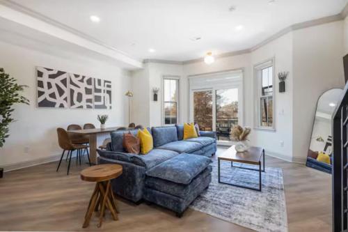 a living room with a blue couch and a table at 2BR - Across from Fairmount Park -10 mins to DT in Philadelphia