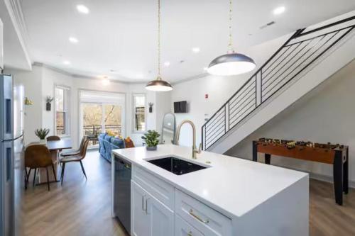 a kitchen and living room with a staircase at 2BR - Across from Fairmount Park -10 mins to DT in Philadelphia