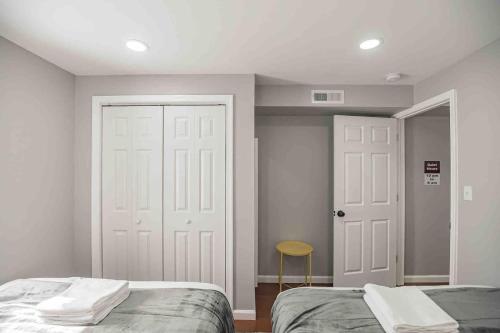a bedroom with two beds and a white door at Cozy 1BR - Center City - Sleeps 4 - 2 Beds in Philadelphia
