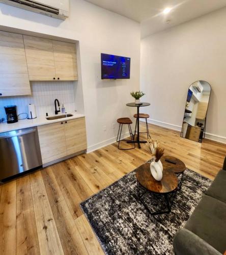 a living room with a couch and a table at Renovated Jr 1BR - Center City - Sleeps 4 - 2 Beds in Philadelphia