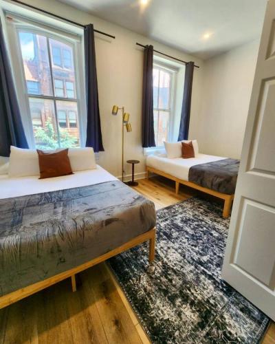 two beds in a room with two windows at Renovated Jr 1BR - Center City - Sleeps 4 - 2 Beds in Philadelphia