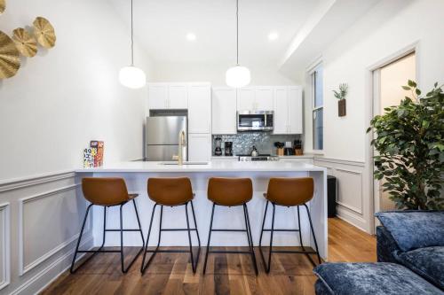 a kitchen with a bar with three stools at 2BR w Balcony - Fairmount Park - 10 mins to DT in Philadelphia