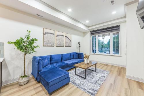 a living room with a blue couch and a table at New 2BR Across from Fairmount Park - 10 Mins to DT in Philadelphia