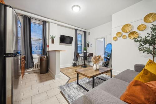 a living room with a couch and a table at Quaint and Cozy Center City 1BR that Sleeps 4 in Philadelphia
