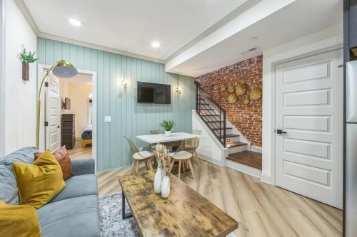 a living room with a couch and a table at Bi-Level 2BR w Rooftop - Sleeps 12 - 10 min to DT in Philadelphia