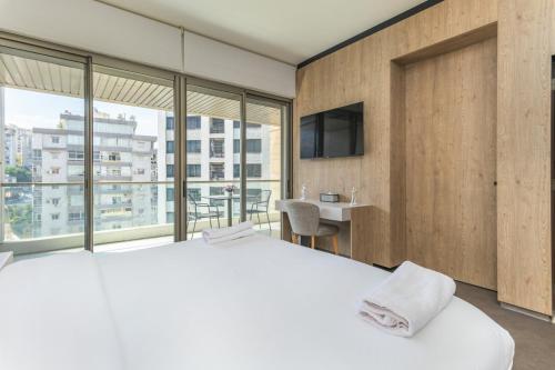 a bedroom with a large bed and a large window at Apex Studio & Balcony in Jounieh in Al Bāţiyah
