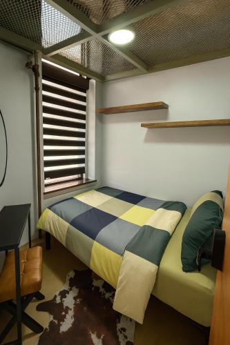 a bedroom with a bed and a window at CityNest Hotel in New York