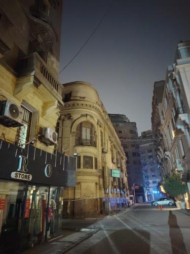 a large building on a city street at night at One Season Hotel in Cairo