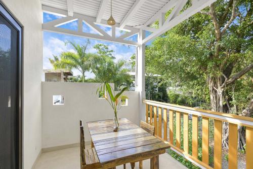a porch with a wooden table with a potted plant on it at Casas Teresa Mar in Santa Teresa Beach