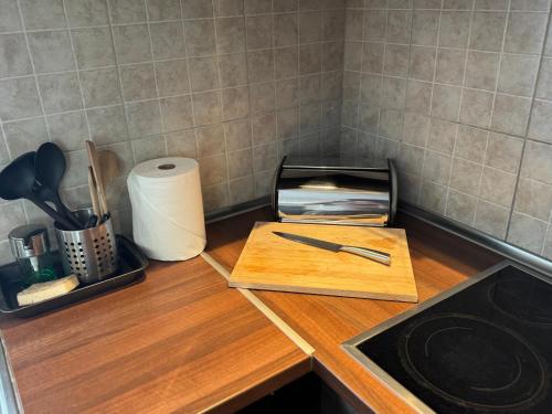 a kitchen counter with a cutting board and a knife at Juicy Private Apartments with Jacuzzi in Szentendre