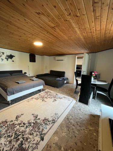 a bedroom with a bed and a couch and a table at Gemütliches Feriendomizil*Eifel* in Bad Münstereifel