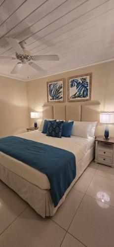 a bedroom with a large bed and two lamps at Jasmine Villas #7 in Castries