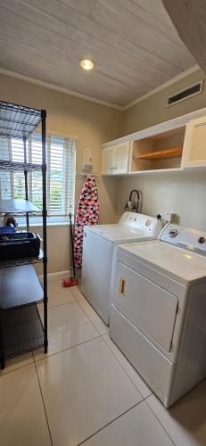 a kitchen with a refrigerator and a washer and dryer at Jasmine Villas #7 in Castries
