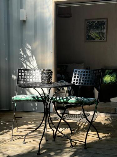 a table and a bench and a table and chair at Tropical Garden Retreat in Napier