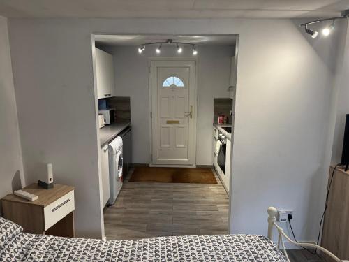 a bedroom with a door leading to a kitchen at Garden lodge in Broadwater