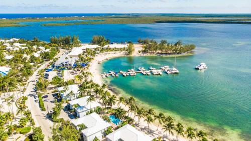 an aerial view of a resort with boats in the water at Kaibo Escape - Beachfront Condo with a Special Last-Minute Rate in Driftwood Village