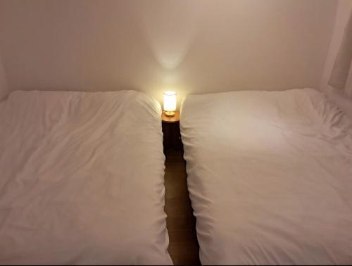 Ένα ή περισσότερα κρεβάτια σε δωμάτιο στο Sodam stay