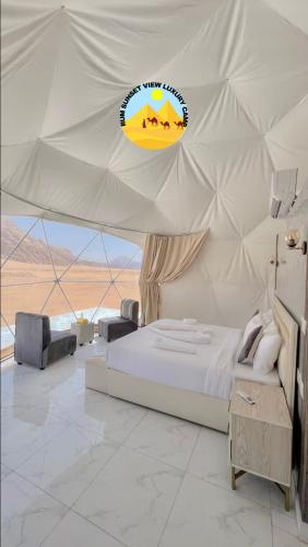 a bedroom with a bed in a tent at RUM SUN SET VIEW BUBBLE lUXURY CAMP in Wadi Rum