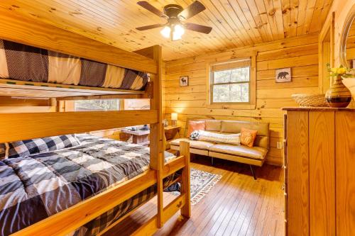 a bedroom with two bunk beds and a couch at Deck and Mtn Views Sunset Ridge Cabin in Murphy in Bellview