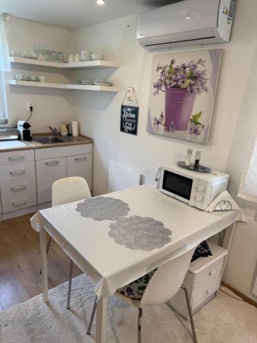 a kitchen with a table with a microwave on it at Juicy Private Apartments with Jacuzzi in Szentendre