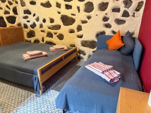 En eller flere senge i et værelse på Finca Las Canitas - Ferienhaus Teneriffa