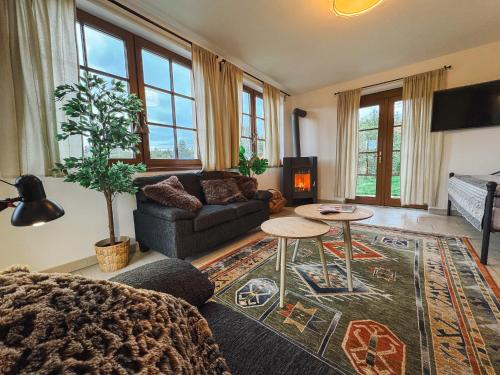 a living room with a couch and a table at Chalupa Lodge in Varvažov