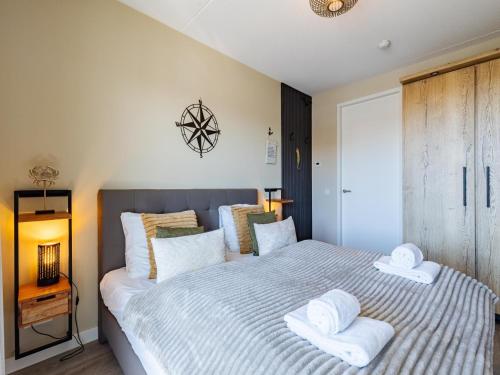 a bedroom with a bed with towels on it at Apartment in Sint-Annaland with Beach Access in Sint Annaland