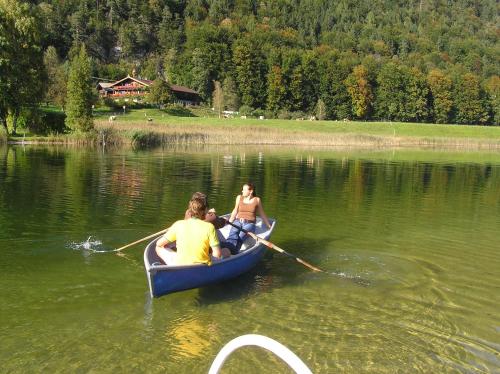 a man and a woman in a boat on a lake at Landhaus Alpbach in Alpbach