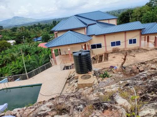 a house with a water tank in front of it at Sako's Home 